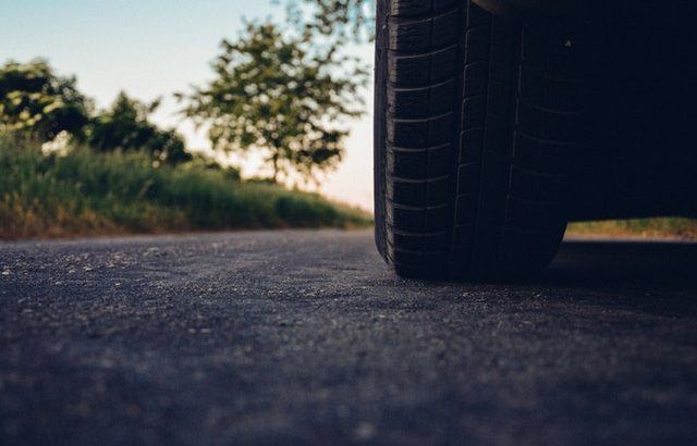 A photograph of a car tyre with the countryside in the background | Smarter Travel Limited