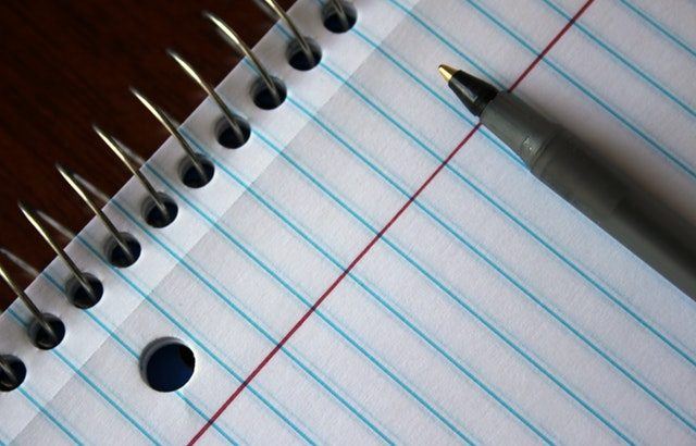 A photograph of a note book and pen | Smarter Travel Limited